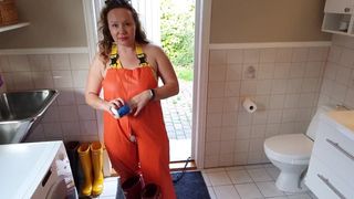 Horny MILF dressing up in rainpants - oiling large melons