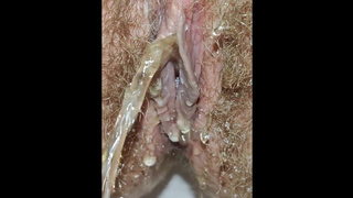 Lovely humongous hairy snatch pissing from urethra close up