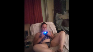 Stunning big bodied woman long hair brunette lifts up her mini dress and smokes cigarettes while playing games